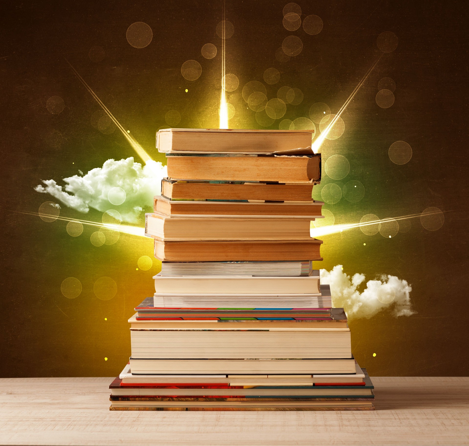 Magical books with ray of magical lights and colorful clouds